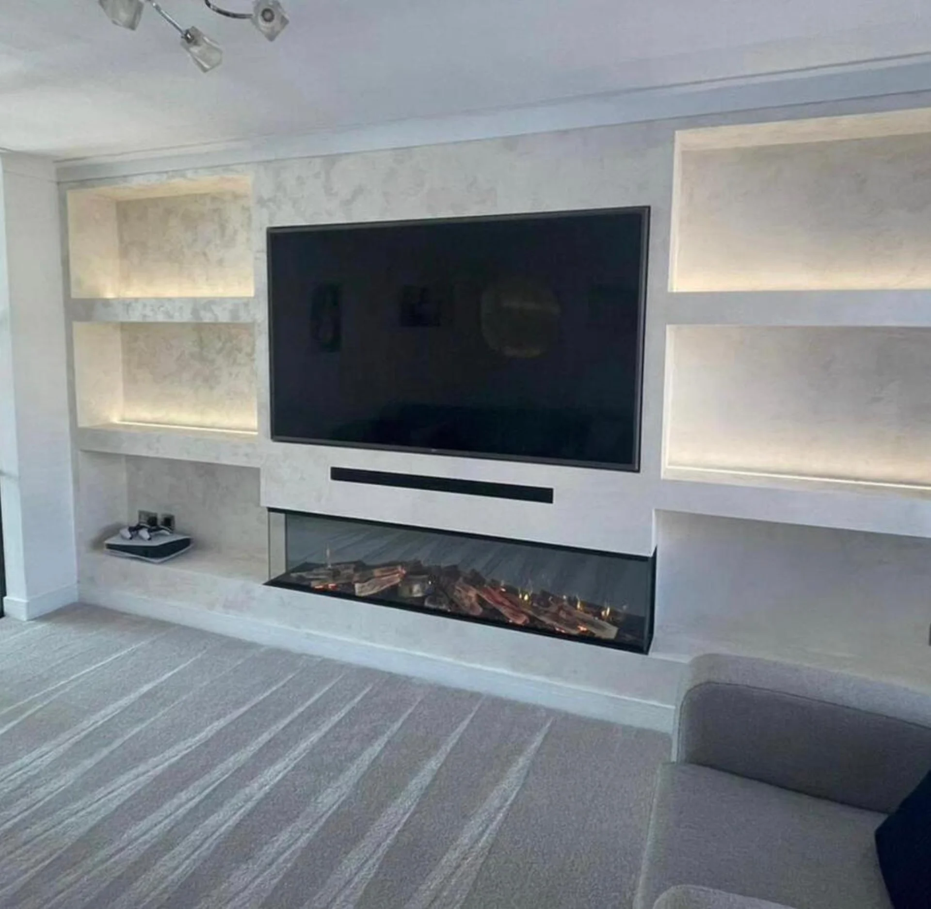 Living room feature wall with fireplace and shelving