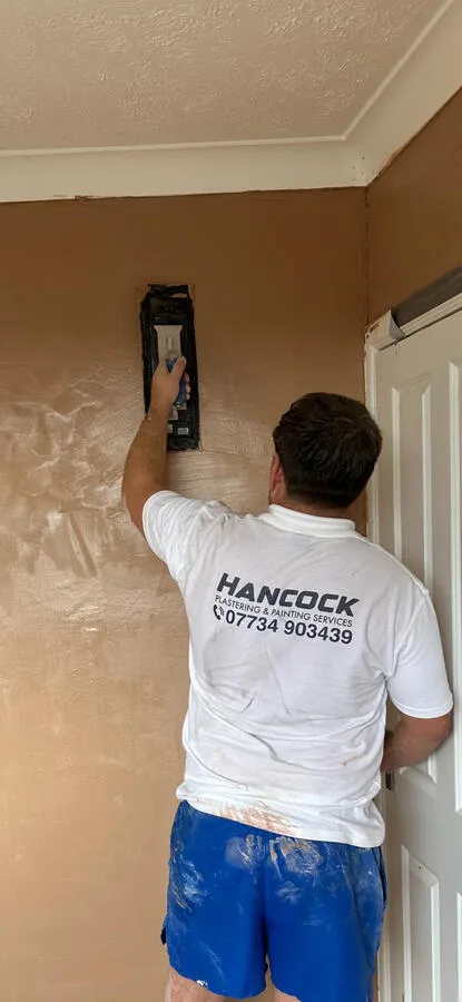 Painter working on wall with roller